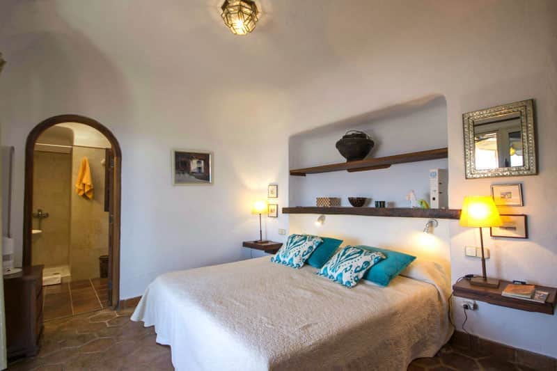 Rocadelmar1 first bedroom doublebed rounded entrance first bathroom wooden bookshelfs