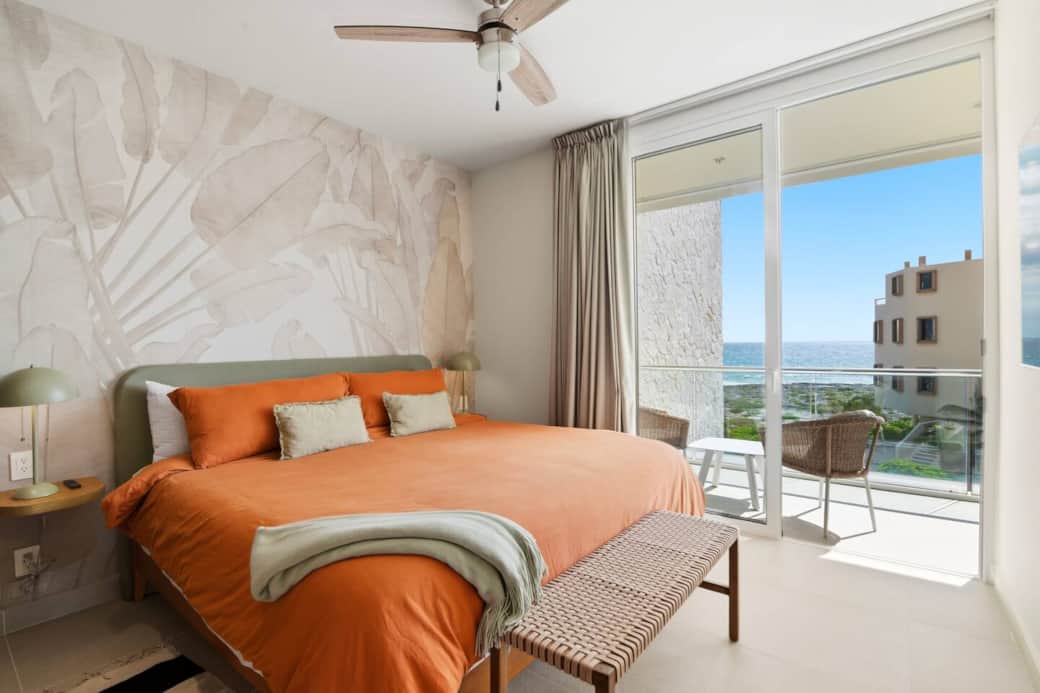 Relax in this comfortable king bedroom with air conditioning, ceiling fan, convenient bedside light switches and outlets for charging devices, plus direct access to your private balcony with ocean views. Relax in this comfortable king bedroom with air conditioning, ceiling fan, convenient bedside light switches and outlets for charging devices, plus direct access to your private balcony with ocean views.