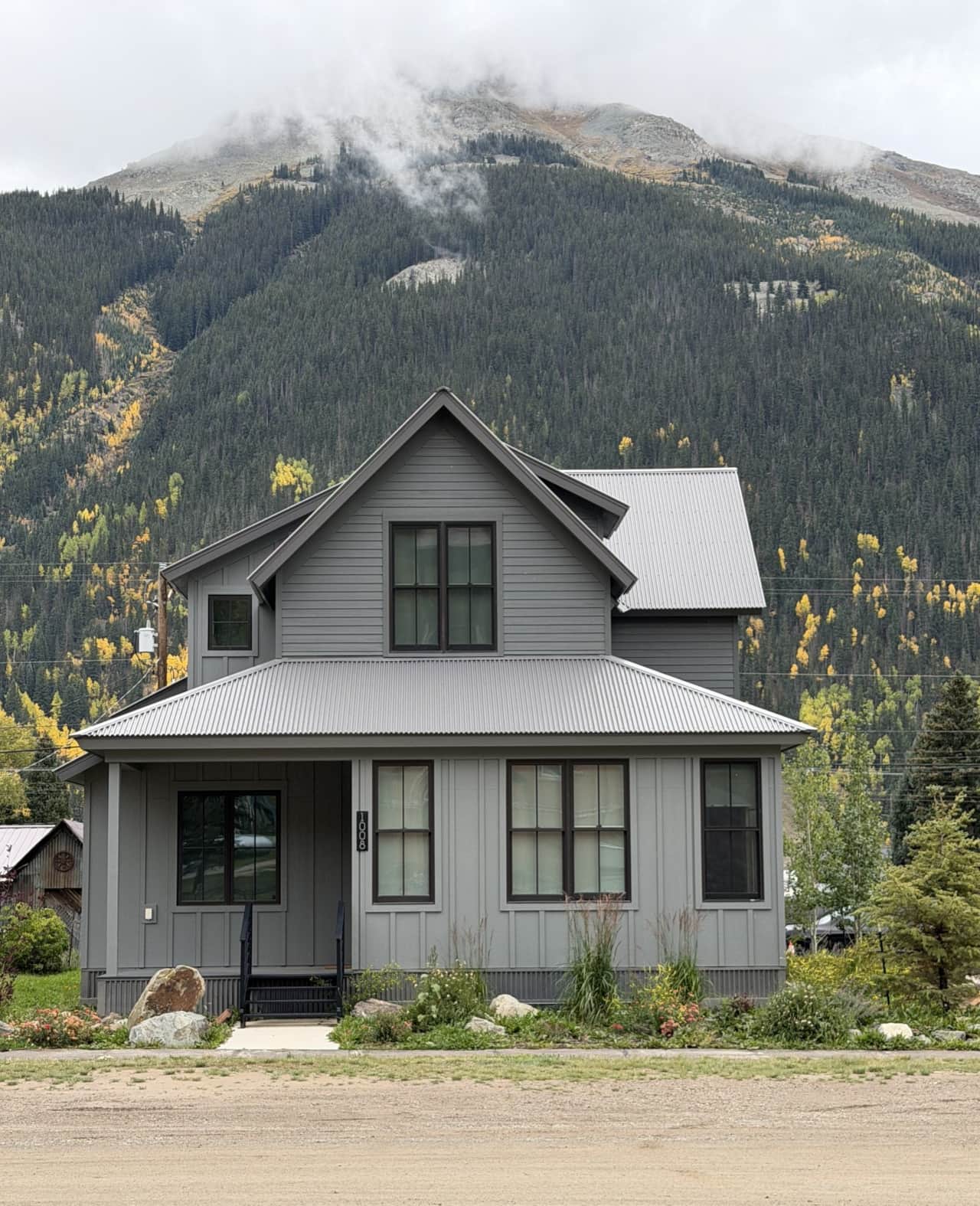 Silverton Summit Retreat in fall, with golden aspens and the San Juan peaks behind