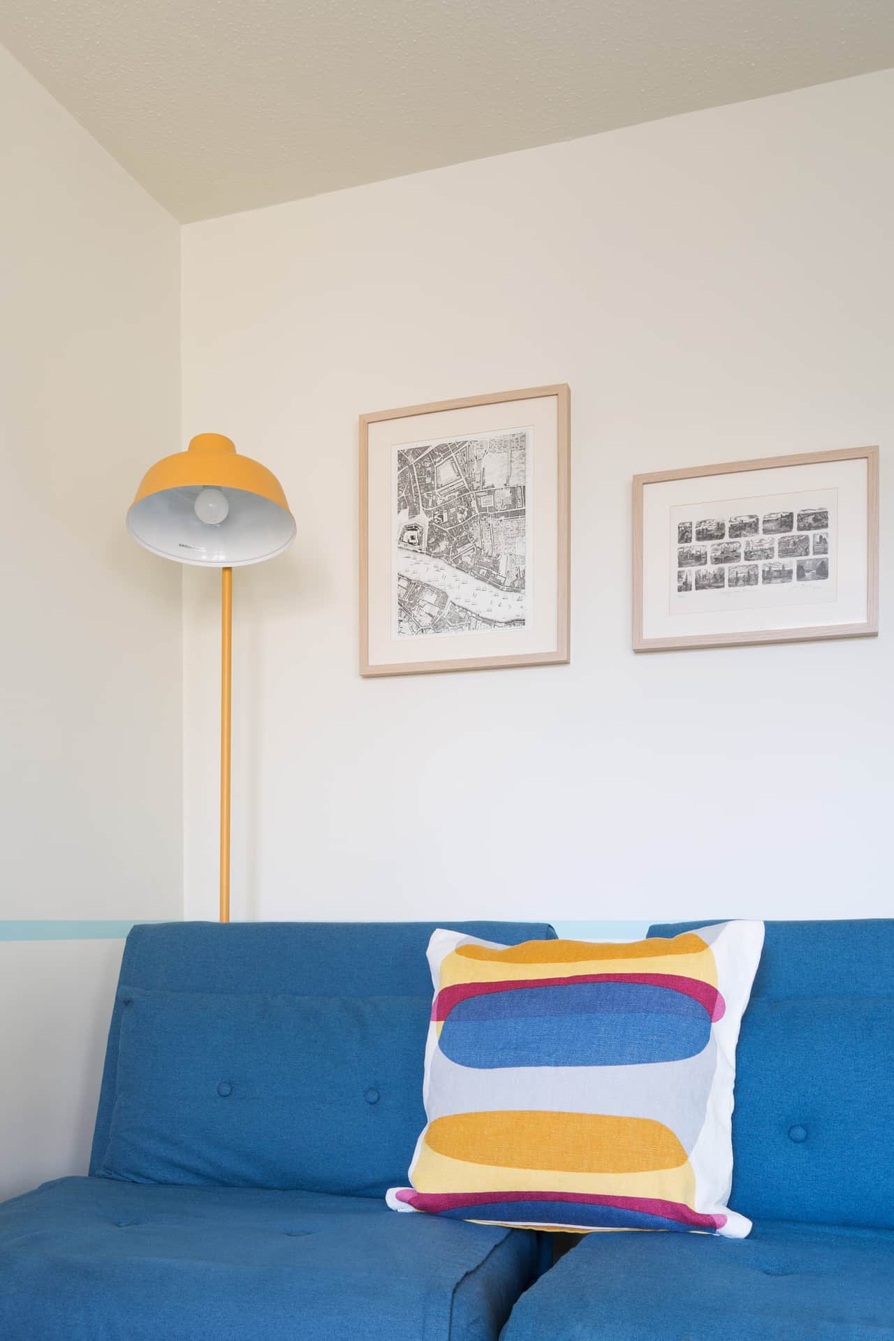 Styling detail: mustard floor lamp and framed antique London maps