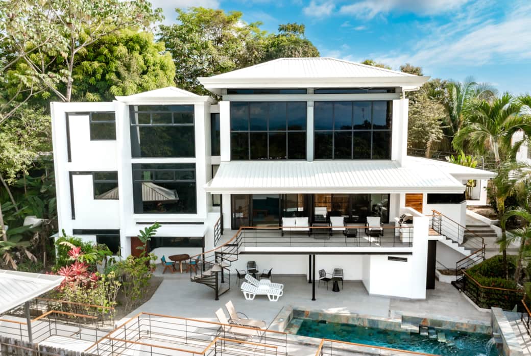 Modern luxury villa surrounded by lush jungle, featuring expansive terraces and a private pool. Modern luxury villa surrounded by lush jungle, featuring expansive terraces and a private pool.