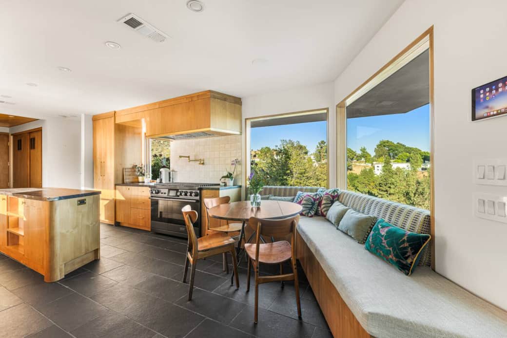 Sunlit breakfast nook with custom bench seating and wide glass windows, creating the perfect spot to Sunlit breakfast nook with custom bench seating and wide glass windows, creating the perfect spot to