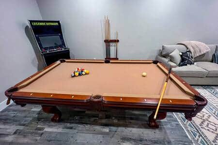 Pool table and arcade, located downstairs in game room.