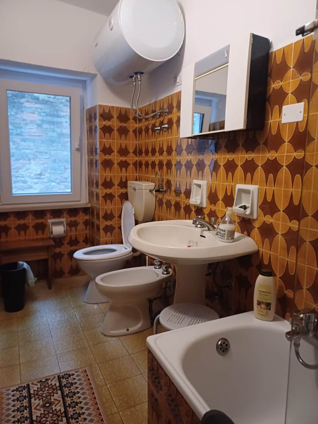 Full bath with tub, bidet, and electric water tank