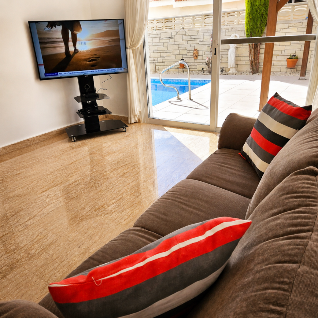 Sunlit living room with pool view