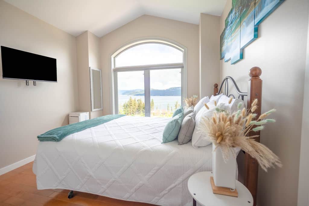 Bedroom with Wall Mounted TV and Natural Light