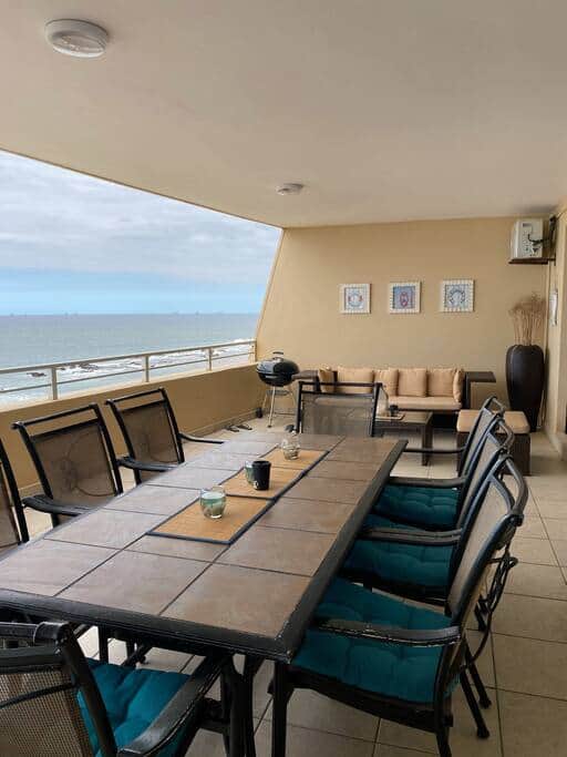 Beautiful views from the balcony with 8 seater dining table and outdoor lounge suite.
