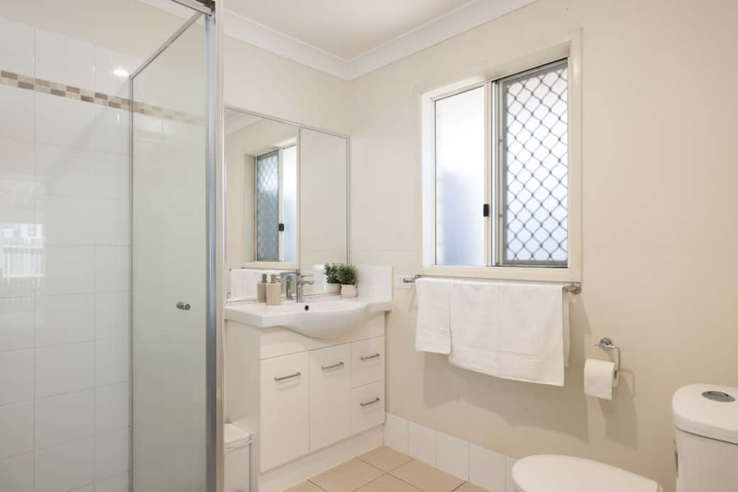 Bathroom: Stylish bathroom with walk-in shower, vanity, and clean finishes