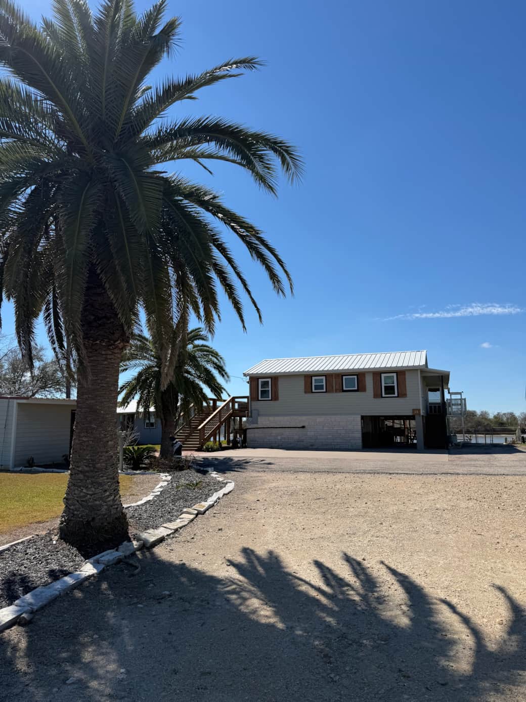 View of the home from the road.  There is lots of parking for visitors and boats.