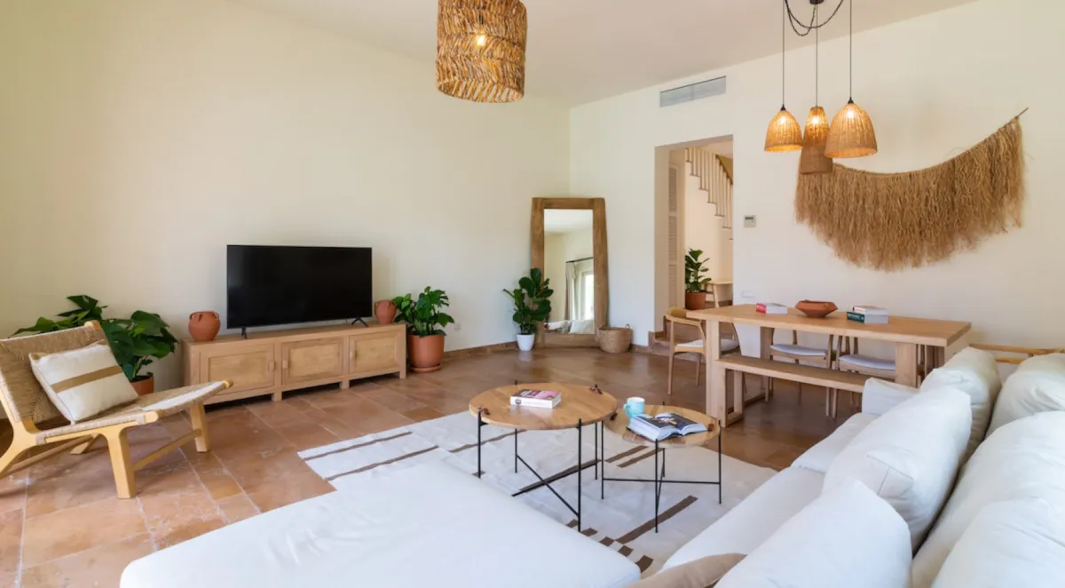 Living room with a sofa, dining table, TV, and plants, Portville B2 008, Gocek