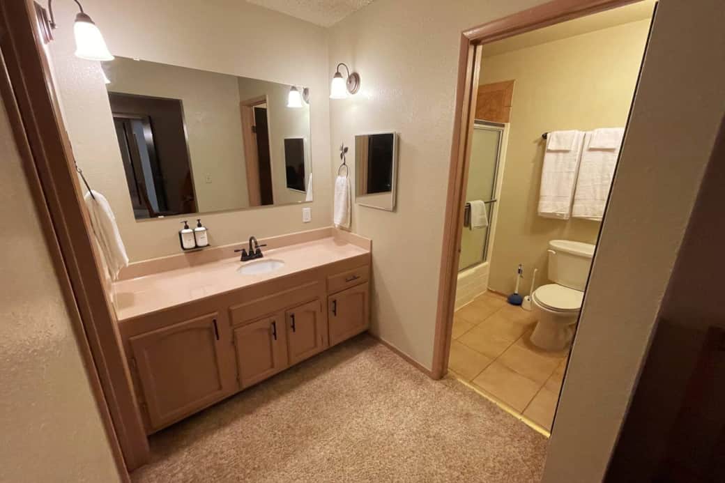The spacious dedicated bathroom attached to the primary bedroom has separation for the vanity and the shower area.
