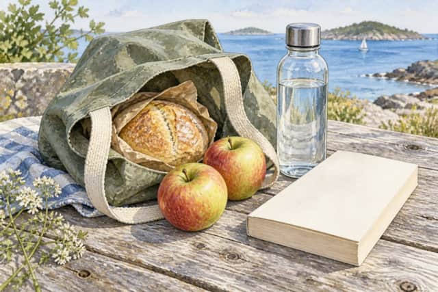 Watercolour illustration of picnic provisions, a water bottle and a book