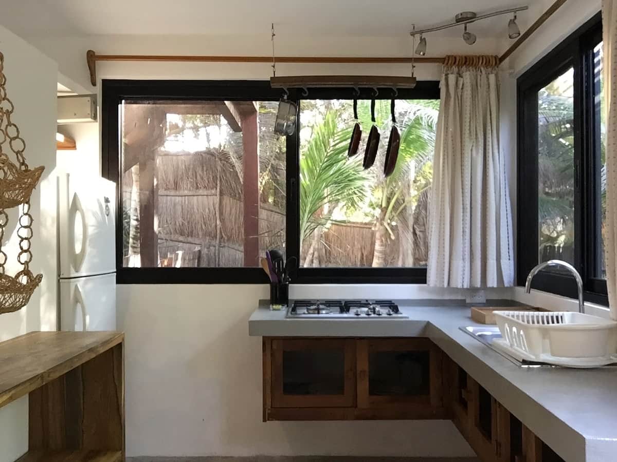 The home's kitchen has a stove, fridge/freezer, blender, coffee maker, kitchen utensils, tableware.