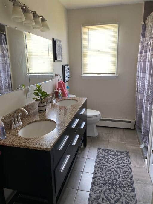 The second floor full bathroom has a double vanity and a shower.