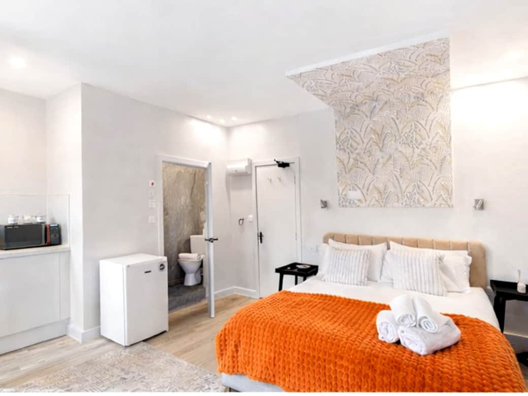 A spacious, beautifully styled bedroom featuring a plush double bed with premium linens A spacious, beautifully styled bedroom featuring a plush double bed with premium linens