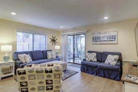 Living room with sofa and coastal decor at 13 Beach Stop Forest Beach condo
