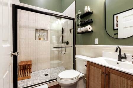 Comfortable and serene full bathroom with large walk-in shower and marble floors