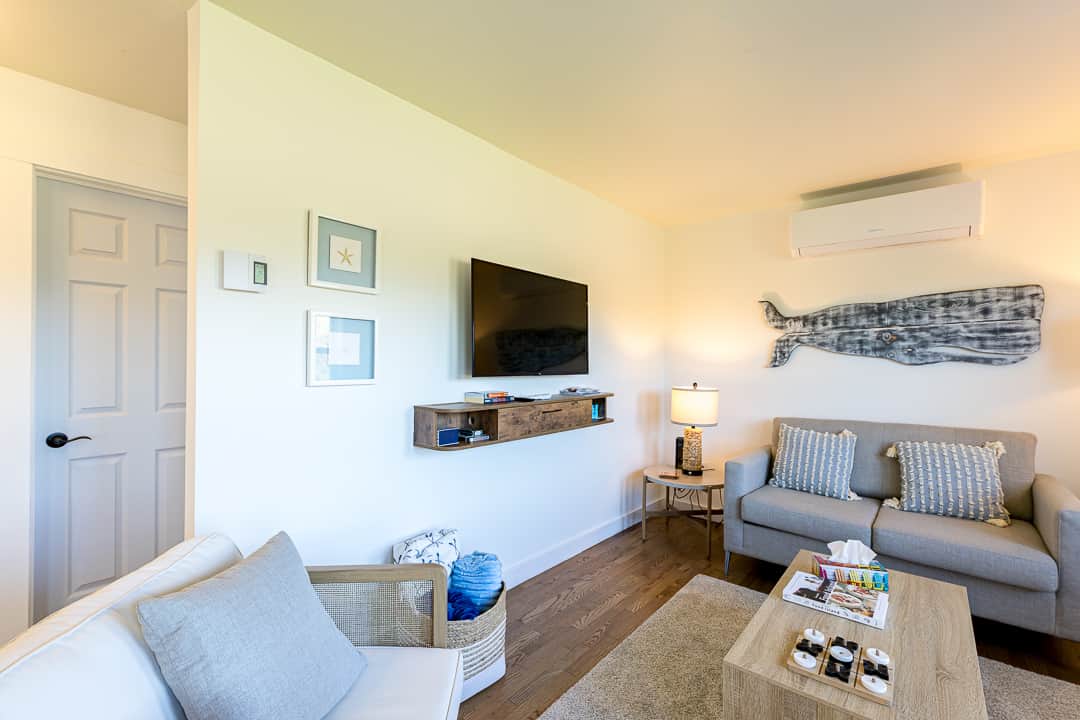 Living room with wall-mounted TV and comfortable seating
