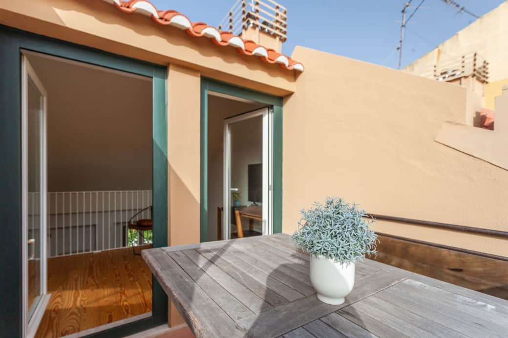 Mezzanine living area with double doors which open out to a rooftop terrace with views if the city