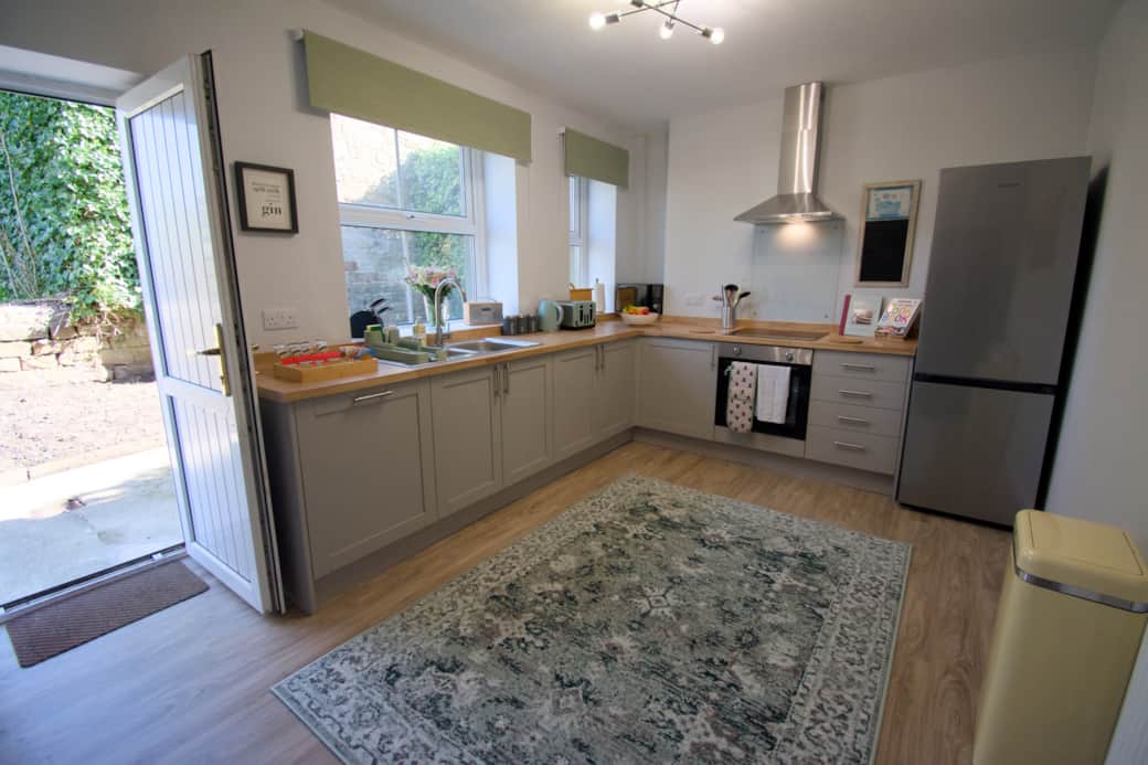 Bright and fully equipped kitchen with direct access to the patio