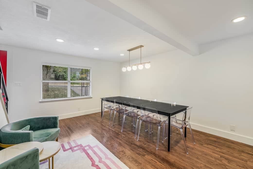 Oversized dining table easily seats 10 people. Dimmable chandelier is flexible for any occasion.