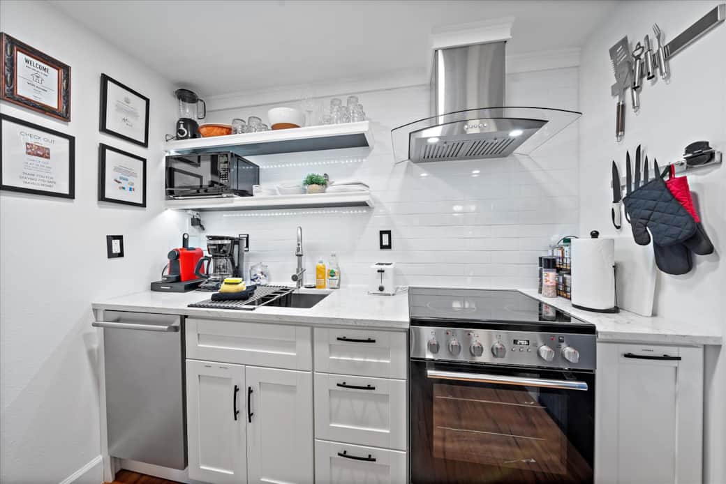 Stocked with spices, olive oil, dishes, silverware, baking pans, mixer, blender, toaster, microwave Stocked with spices, olive oil, dishes, silverware, baking pans, mixer, blender, toaster, microwave