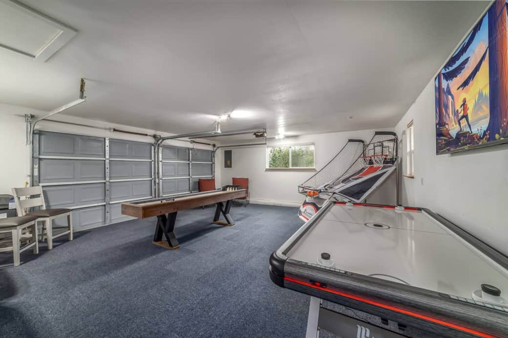 Game room with Air hockey table, arcade basketball game, shuffleboard table and Roku smart TV Game room with Air hockey table, arcade basketball game, shuffleboard table and Roku smart TV