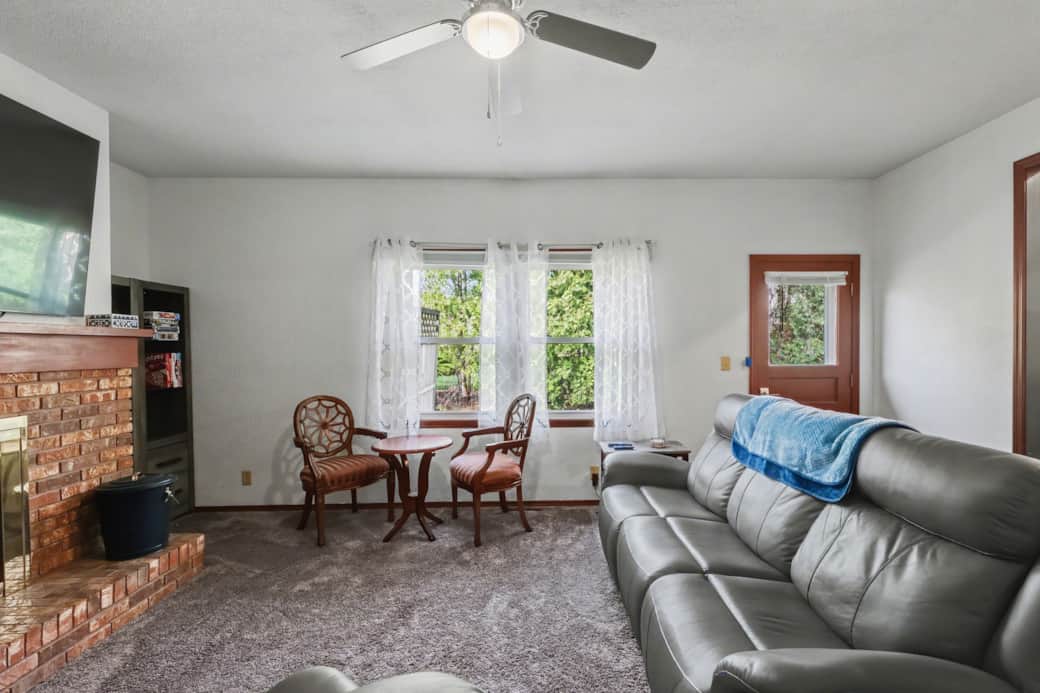 Family Room with a large Roku TV, a work area with a monitor and power, plenty  seating and games.