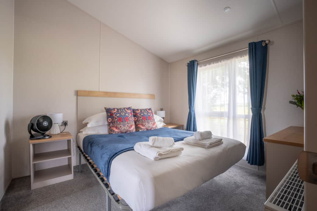 Wake up refreshed in the peaceful master bedroom with countryside views