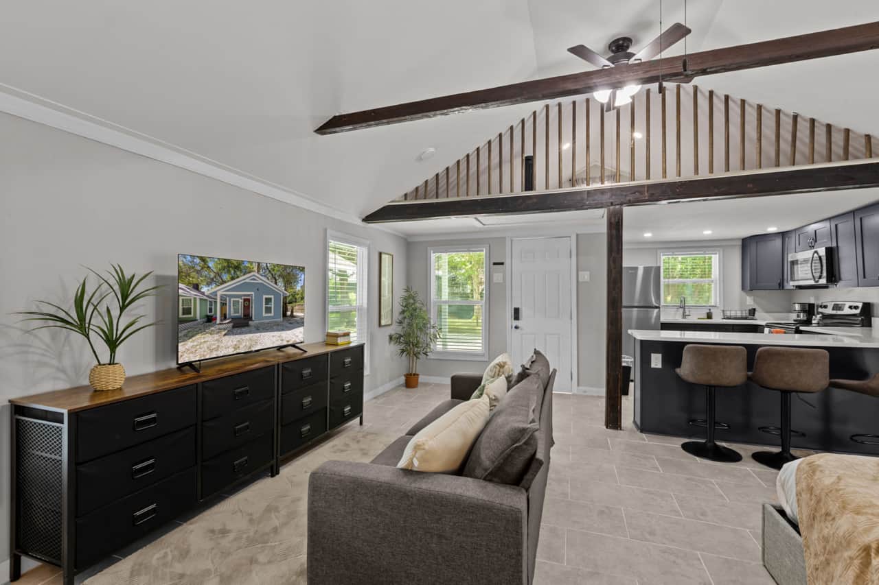 Living room with 50in SMART TV, dresser, Sofa, Kitchen view and second floor view. 2 cealing fans!