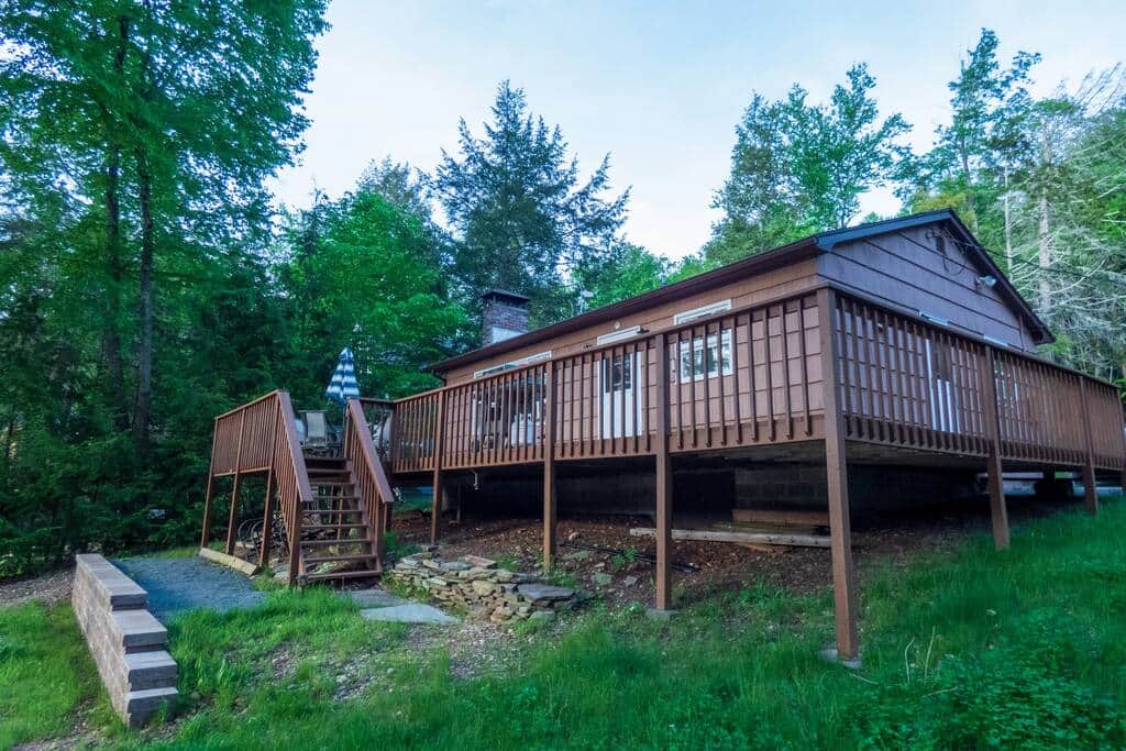 Cottage is surrounded by a massive deck on 2 sides.