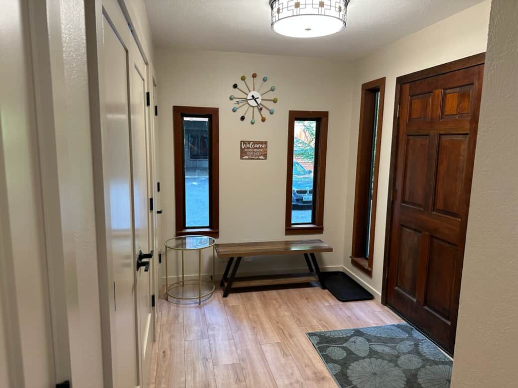 The front door is unlocked with a personal key code and leads to the main entry of the house. There's a shoe tray and a comfortable bench just inside where you can take off your shoes.
