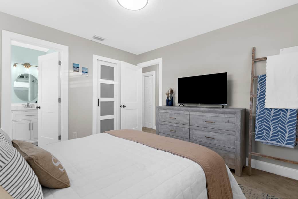 Bedroom Retreat: Stylish decor and en-suite access, perfect for restful nights after beach days!