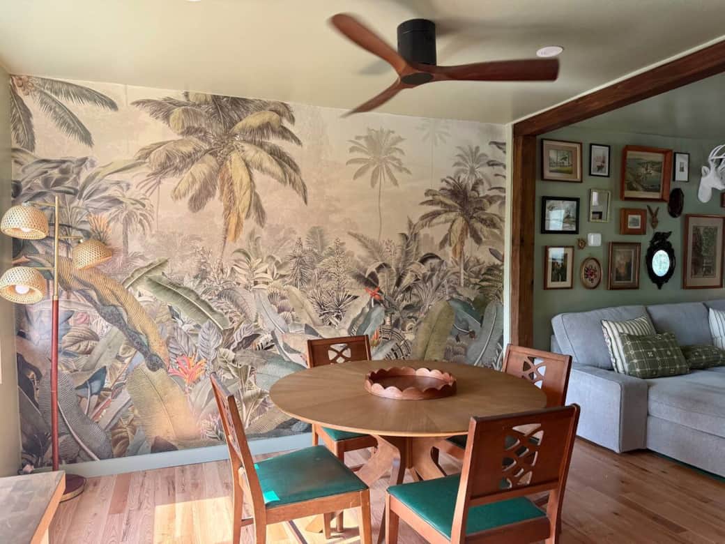 Open floor plan dining room leading to living room. Ceiling fans in dining room and separately in living room.  