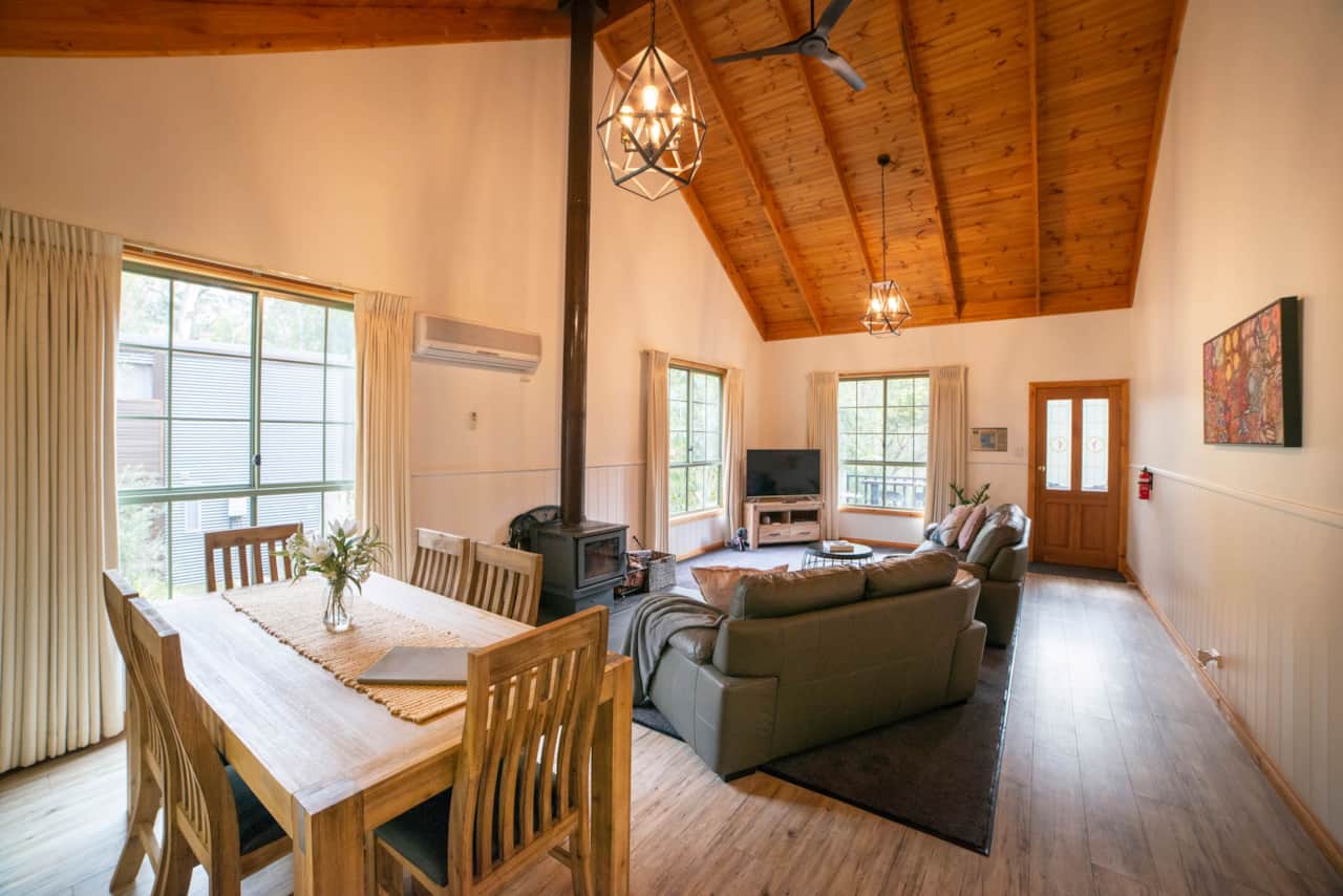 Experience comfort with cathedral ceilings, AC, wood heater, and fans in this cozy retreat.