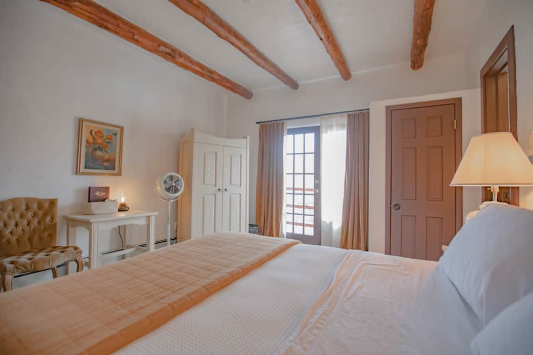 High quality standing fan and AC unit in window.