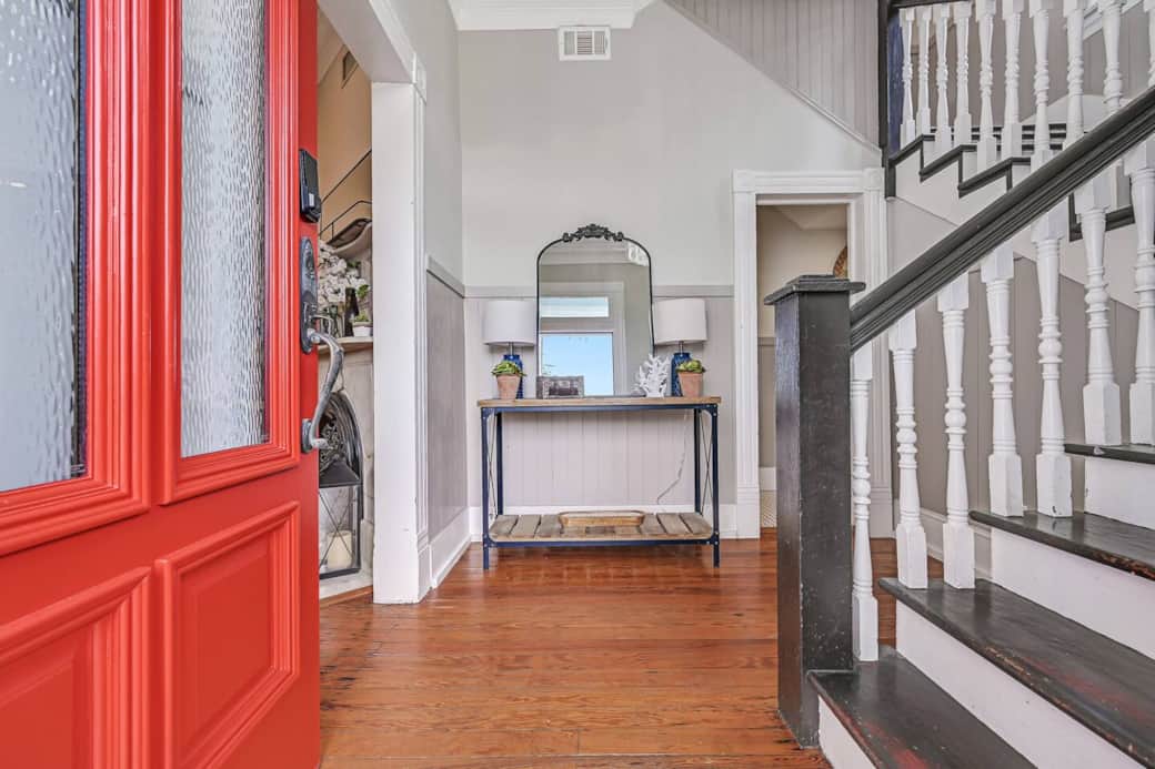 Enter from front porch and private seating area into the historic foyer with beautiful, original, stately staircase, quirky half bath, and entry to main living room. Enter from front porch and private seating area into the historic foyer with beautiful, original, stately staircase, quirky half bath, and entry to main living room.