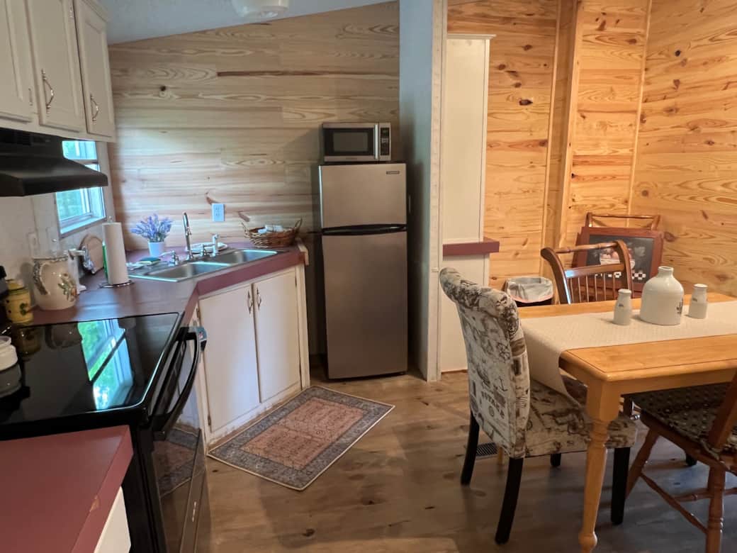 Entry into kitchen. Stove, fridge/freezer, dining table