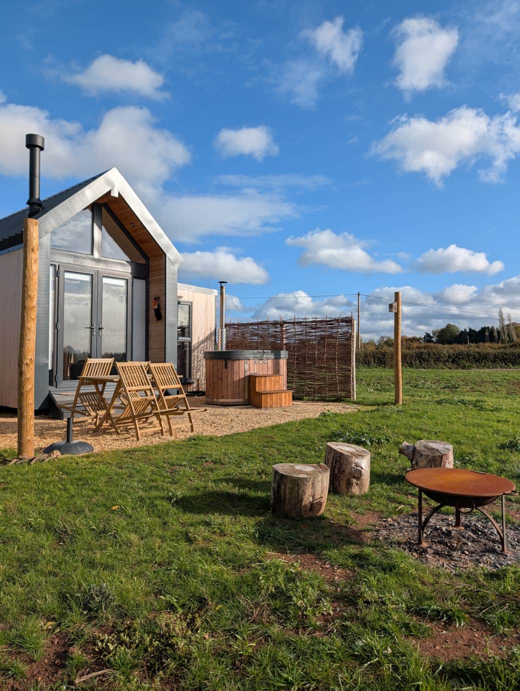 Patio with log fired hot tub, garden furniture and fire pit