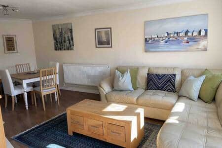 Spacious lounge, with a dining table. 