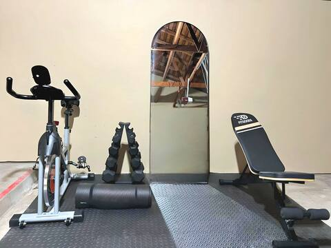 Enjoy a good workout with exercise bike, yoga mat, dumbbells and exercise bench!