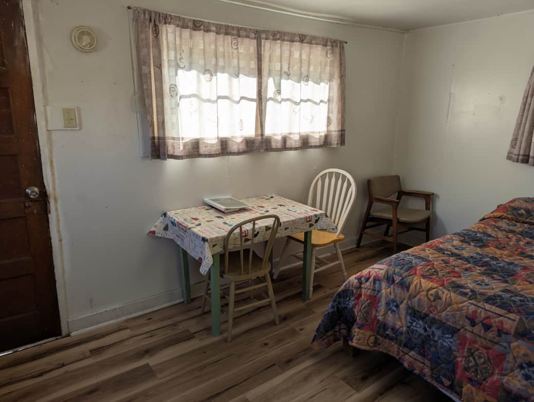 Cabin 9 is a cozy rustic cabin that features a wood-burning stove.