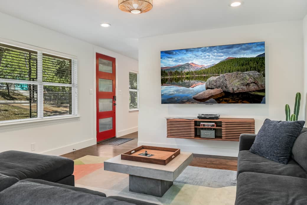 Entertainment central: 85" 4K QLED TV with provided cable and local channels via YouTube TV.