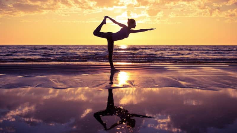 Private beachfront yoga and wellness session at sunrise arranged by Villa Sueño concierge