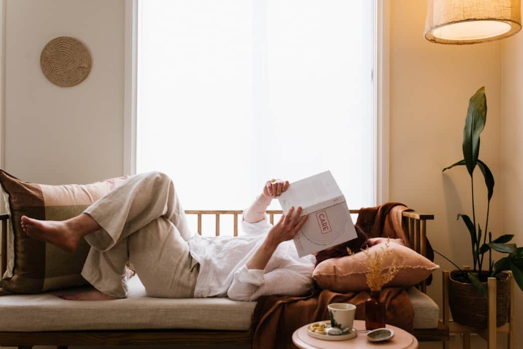 A sun‑drenched daybed made for unhurried reading and warm, gentle sips of tea.