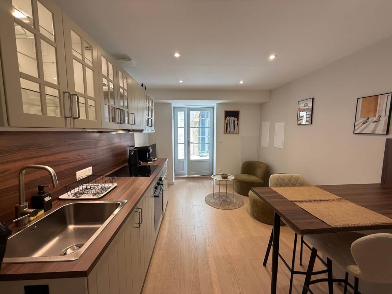 Living and dining area with equipped kitchen.