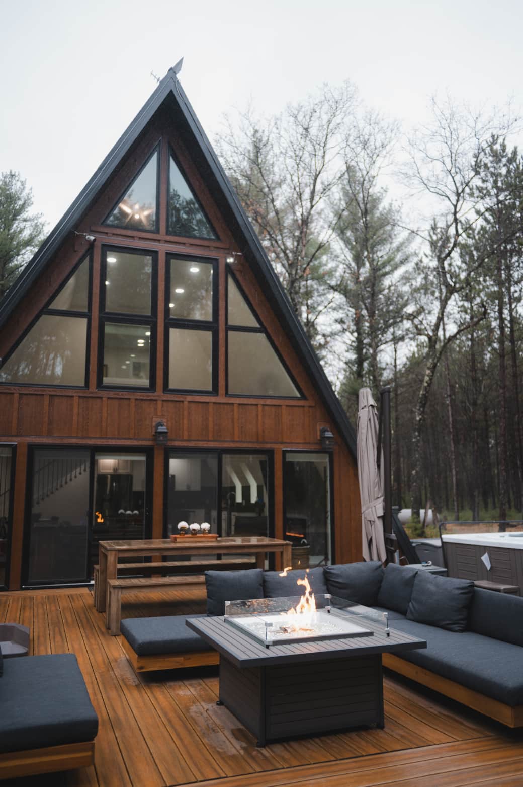 Our outdoor patio with hot tub, cold tub, sauna, fire table, grills, and seating