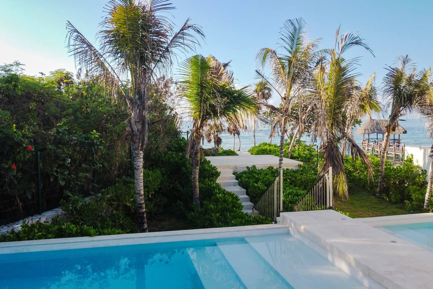 Beautiful beach club with two pools and stunning ocean views—the perfect place to relax, unwind, and enjoy the tropical scenery.
