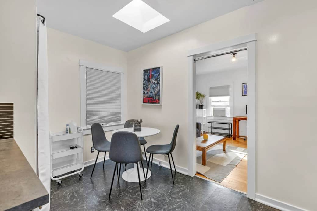 Dining area with a round table and 4-seat setup, ideal for meals or casual chats. Dining area with a round table and 4-seat setup, ideal for meals or casual chats.