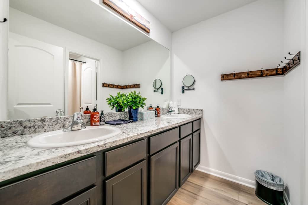 Bathroom with dual sinks with bathtub / shower &amp; toilet in a separate room